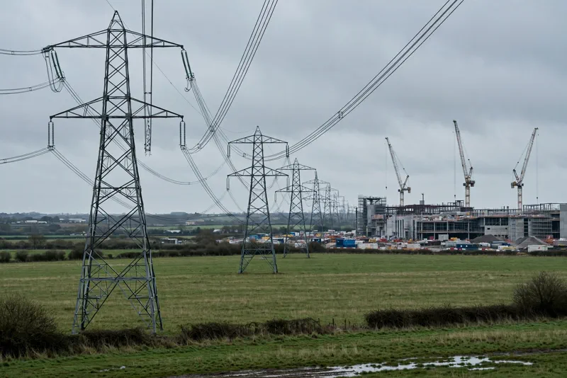High voltage electricity pylons leading toward a half built data center construction site in England