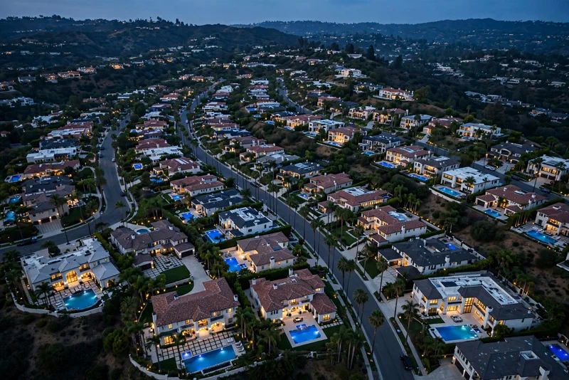 Aerial view of luxury mansions in Beverly Hills, California, at dusk.
