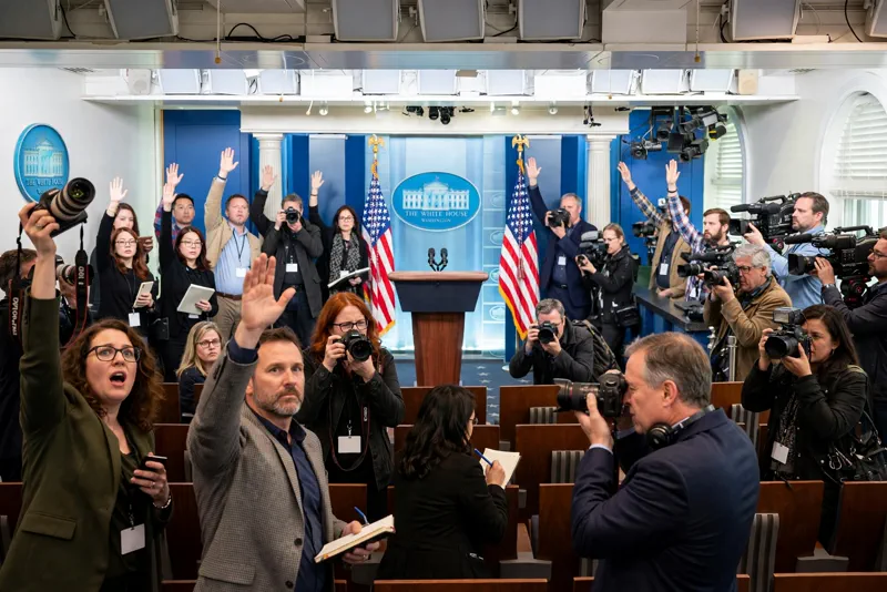 Journalists with cameras in the packed White House press briefing room